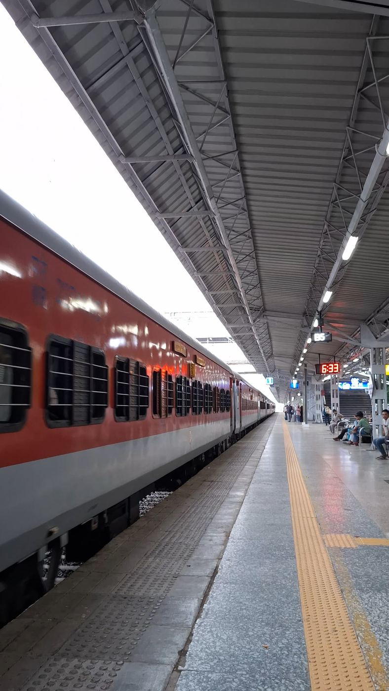 Red coaches along a covered platform