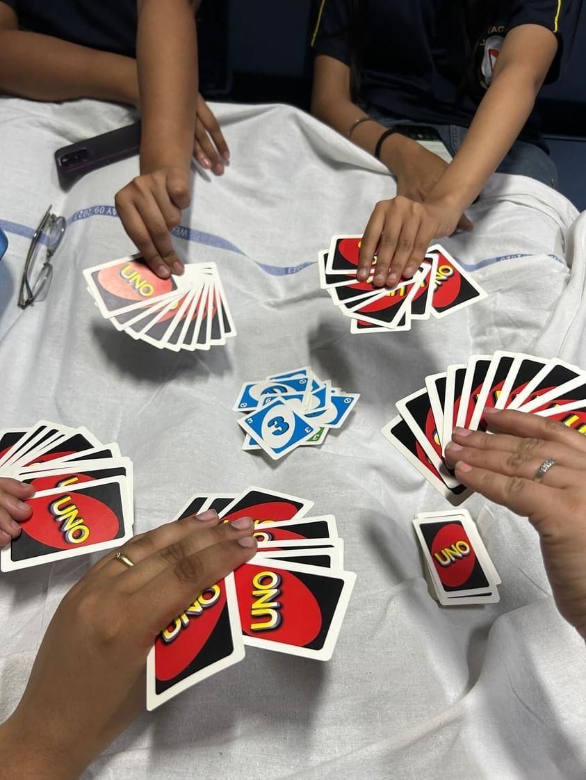 Friends playing Uno on a train berth